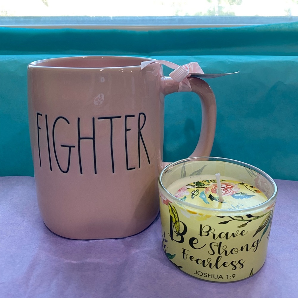 Rae Dunn Komen Ribbon FIGHTER mug with a BE BRAVE STRONG FEARLESS candle.